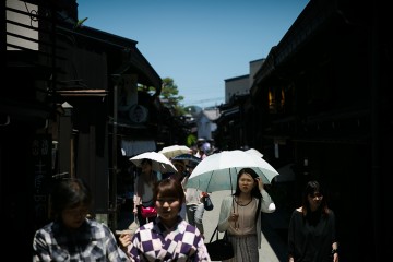 Tourists explore old town Takayama.