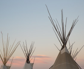 The sun sets as festivities continue at North American Indian Days in Browning, Montana.